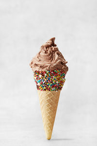 Close-up of ice cream cone against white background