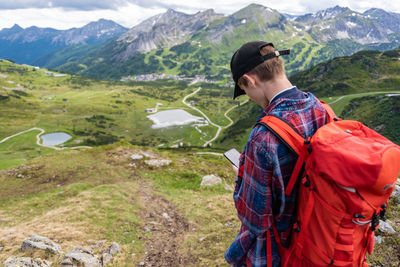 Rear view of hiker standing on mountain