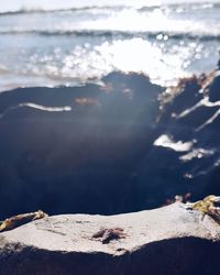 Close-up of rocks on beach against sky