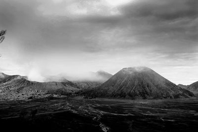 View of volcanic landscape against cloudy sky