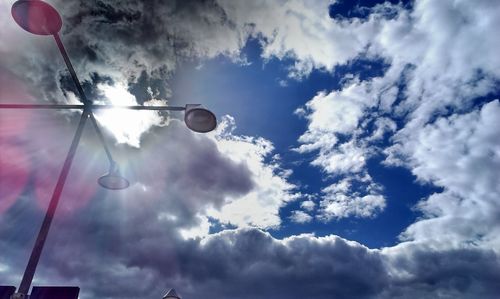 Low angle view of street light against cloudy sky