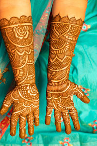 Midsection of bride showing henna tattoo