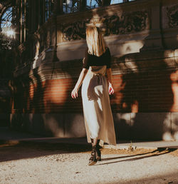 Rear view of woman walking on street in city