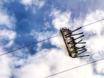 Low angle view of cranes against sky