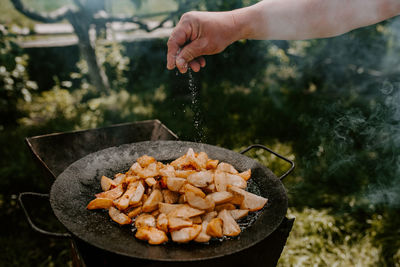 Cropped hand of man preparing food