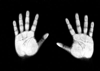 Close-up of human hand against black background