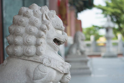 Close-up of statue against temple building