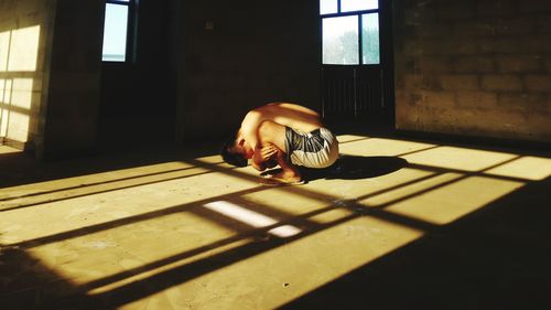 Depressed man crouching in prison