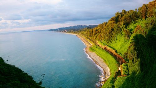 Scenic view of river against cloudy sky