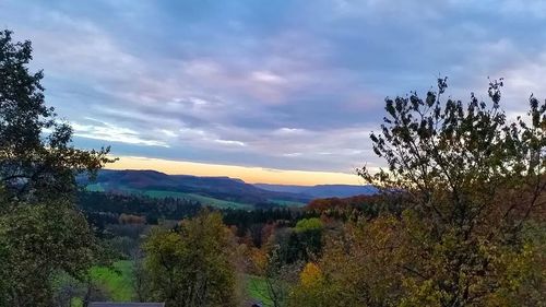 Scenic view of mountains against cloudy sky