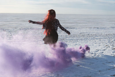 Full length of woman in sea against sky