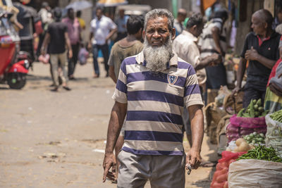 Full length of man standing on street in city