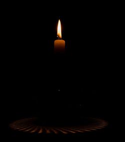 Close-up of illuminated lamp in darkroom