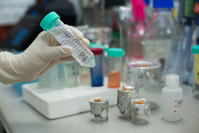 Cropped hands testing chemicals in laboratory