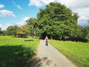 Full length of girl walking on field