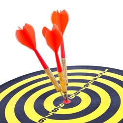 Close-up of darts on bulls eye against white background