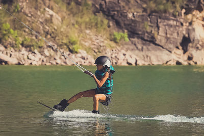 Girl kiteboarding in sea