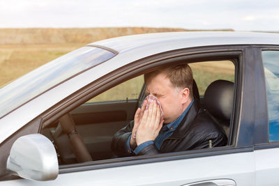 Portrait of man in car window