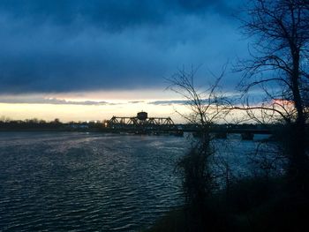 Scenic view of river at sunset