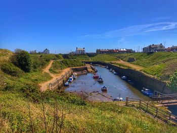 High angle view of road by canal against sky