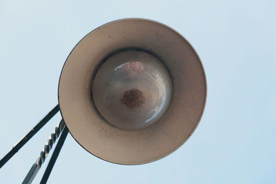 Low angle view of electric lamp against sky