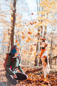 Side view of woman with dog on field