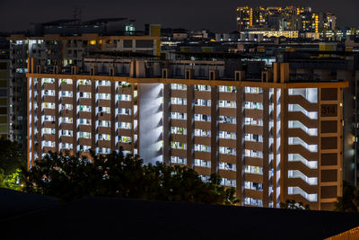 Modern buildings against sky at night