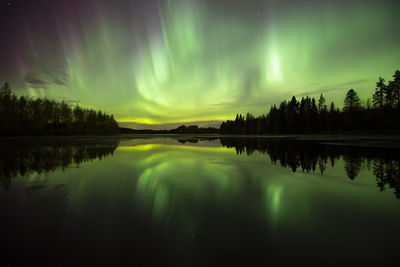 Scenic view of lake against sky at night