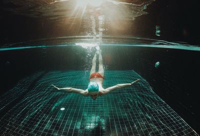 High angle view of woman swimming in pool