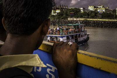 Man looking at boat from another boat