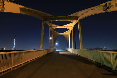 Empty bridge against clear sky at night