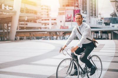 Portrait of man riding bicycle on city street