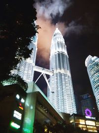 Low angle view of skyscrapers lit up at night