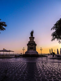Silhouette of buildings against clear sky at sunset