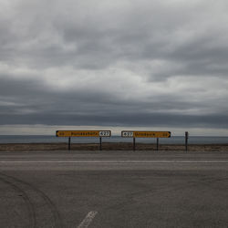 Empty road against cloudy sky