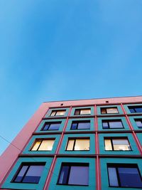 Low angle view of building against clear blue sky