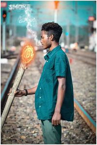 Side view of young man looking at city