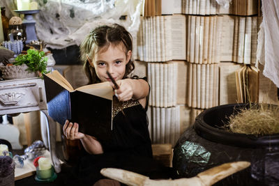 Portrait of cute girl showing magic trick