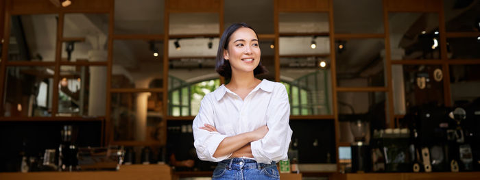 Portrait of young woman standing in gym