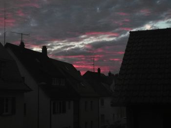 Low angle view of buildings against dramatic sky