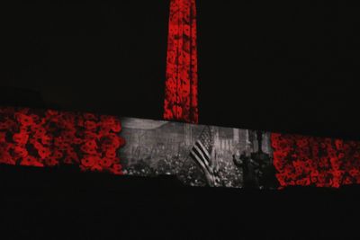 Close-up of text on red wall at night