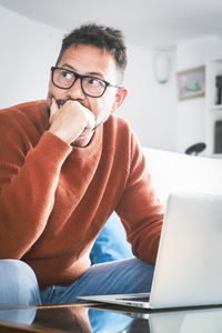 Young woman using laptop at home