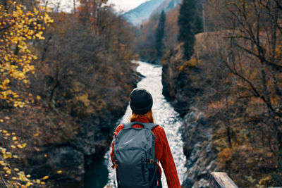 Rear view of man looking at mountain during autumn