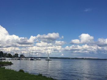 Sailboats in sea against sky