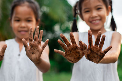 Cute friends showing dirty hands