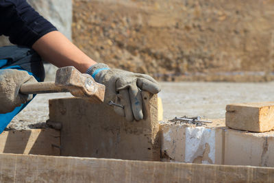 Midsection of man working at workshop