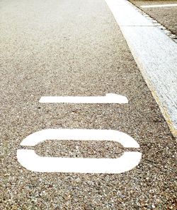 High angle view of arrow sign on road