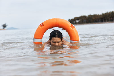 Young man swimming in lake