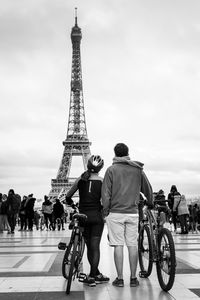 Rear view of people walking on tower in city