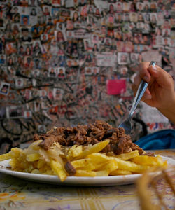 Close-up of hand holding ice cream in plate